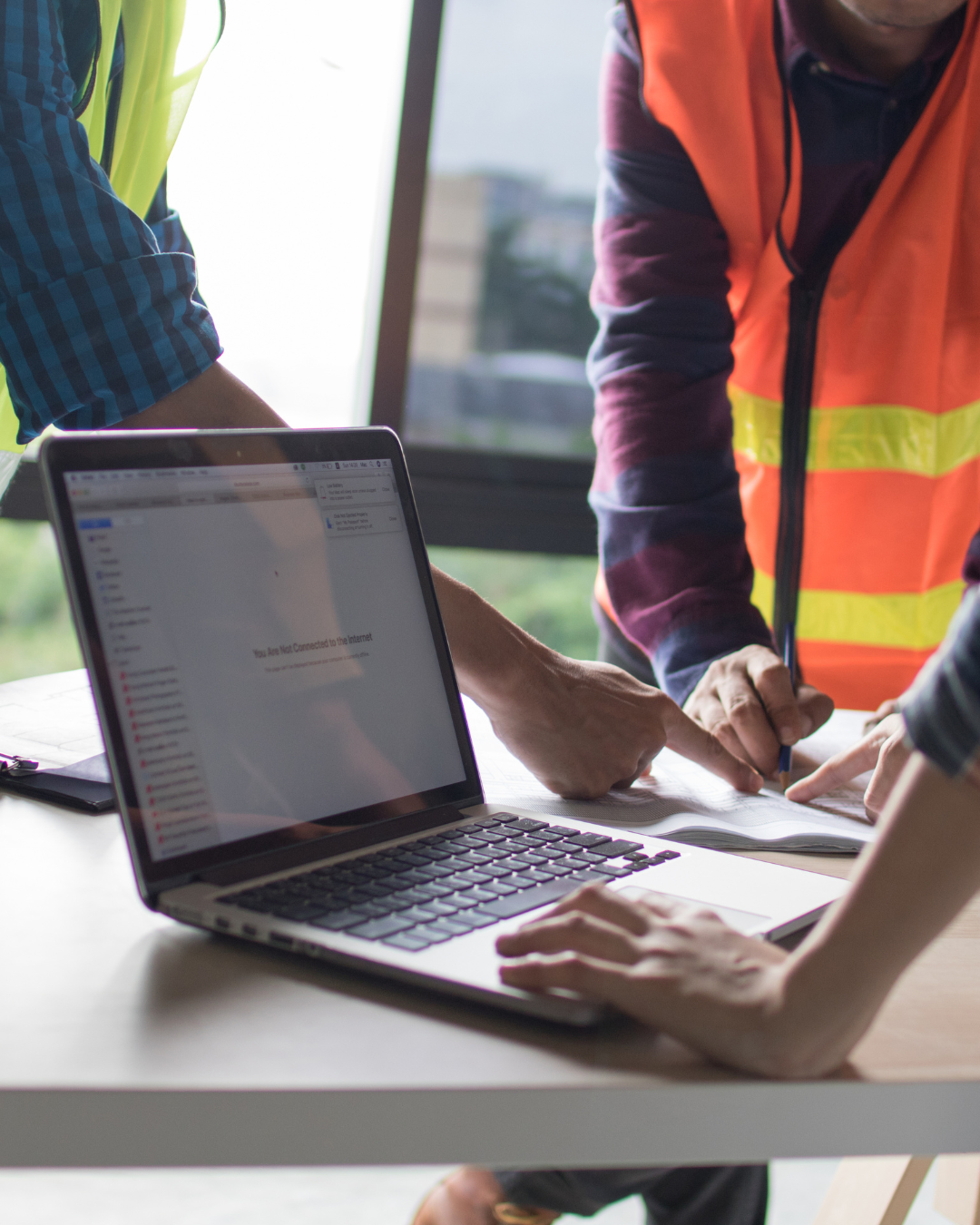 Contractor reviewing job costs at mid-year
